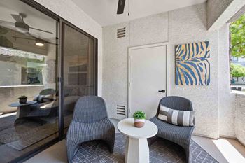 a small patio with two chairs and a table